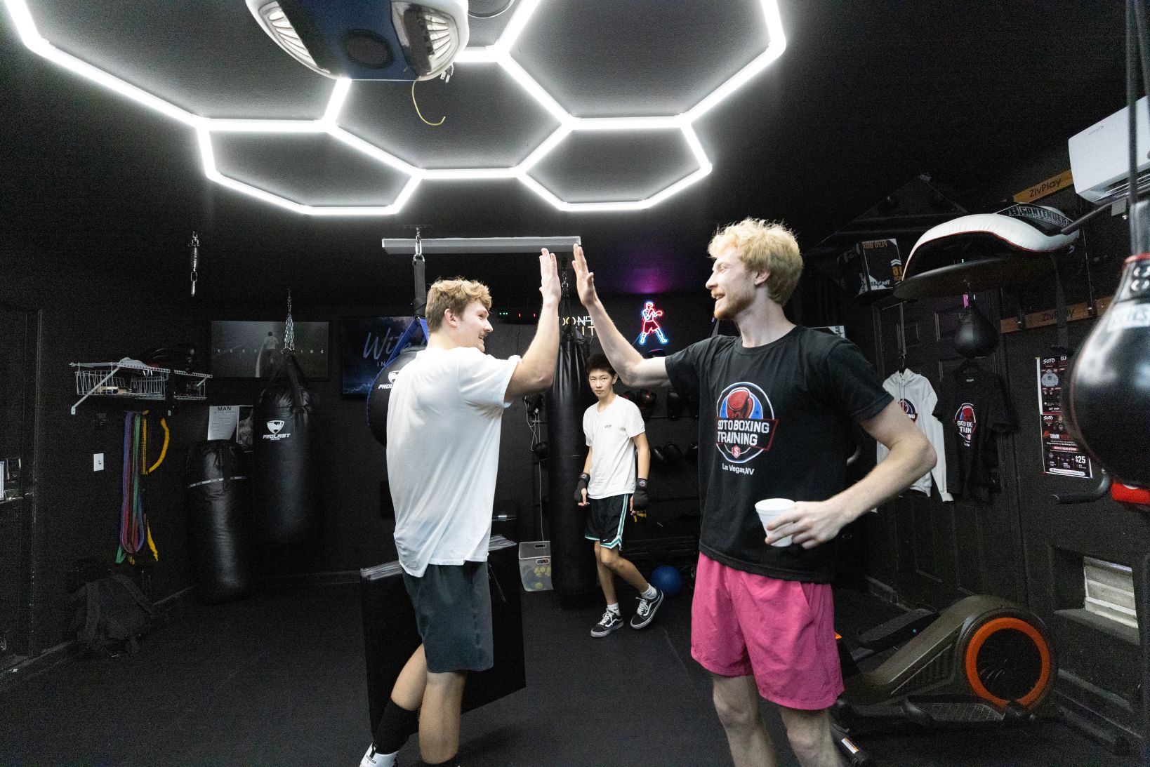 A coach and member sharing a high-five